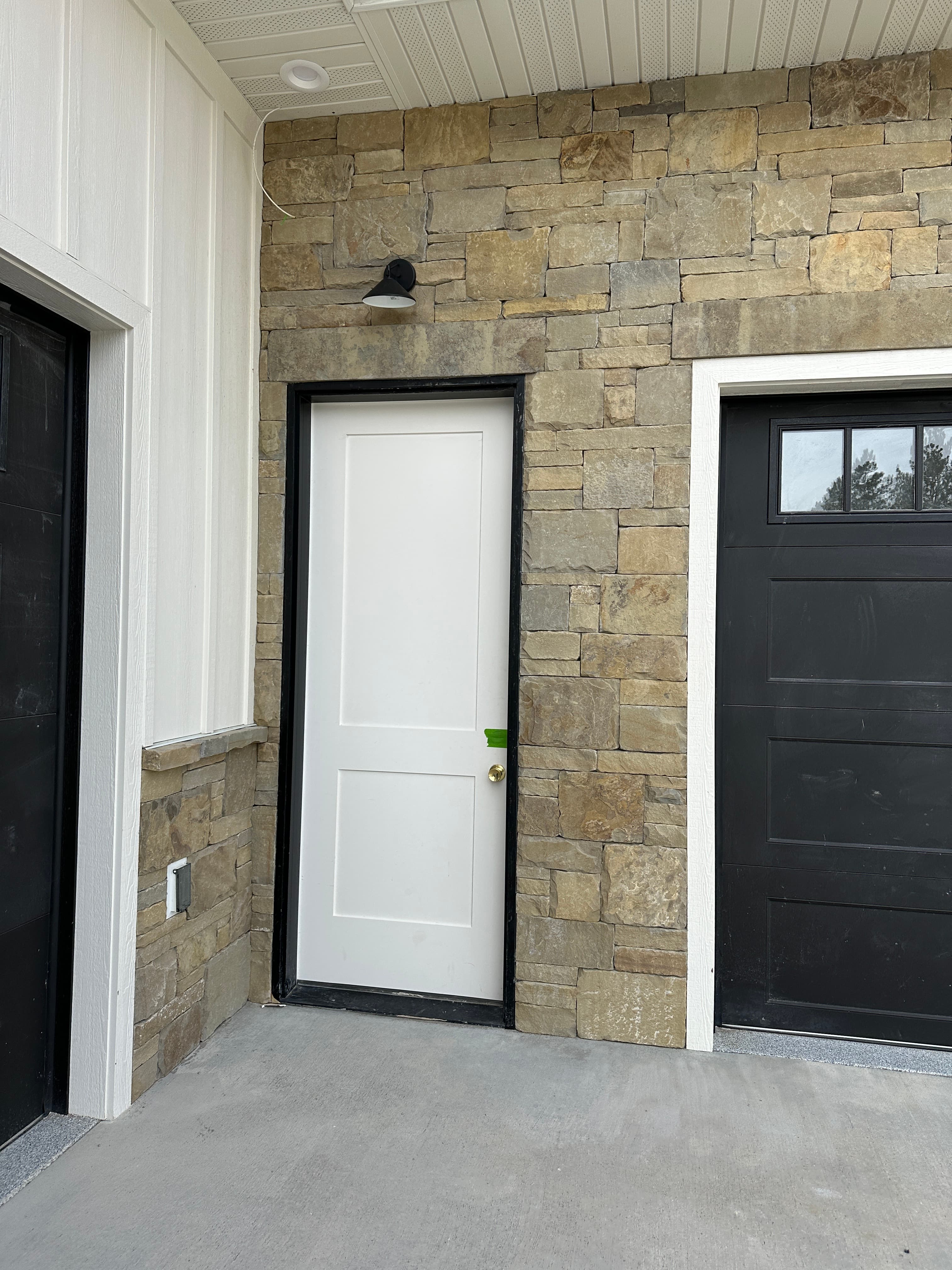 Stone veneer around entry door and windows